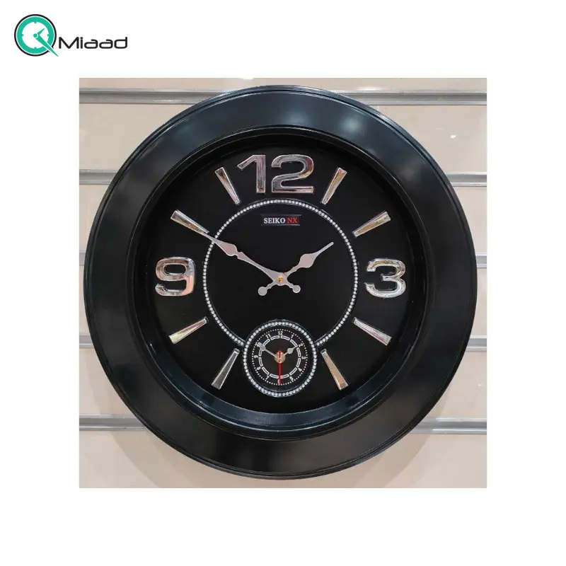 ساعت دیواری سیکو مدل NX، ساعت دیواری دو زمانه با تنوع رنگی، دارای موتور روانگرد و اعداد برجسته آبکاری شده لاتین، سایز 50، رنگ مشکی نقره ای ساعت سیکو