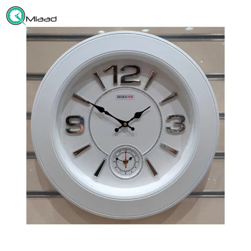 ساعت دیواری سیکو مدل NX، ساعت دیواری دو زمانه با تنوع رنگی، دارای موتور روانگرد و اعداد برجسته آبکاری شده لاتین، سایز 50، رنگ سفید نقره ای ساعت سیکو