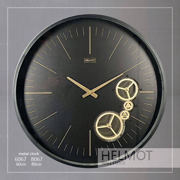  ساعت دیواری مدل هلموت، ساعت دیواری مدرن در دو سایز،متریال فلزی بدنه، دارای چرخ دنده های متحرک، ترکیب رنگ مشکی طلایی، موتور ساخت تایوان با 5 سال ضمانت، سایز 60 | کد 6067