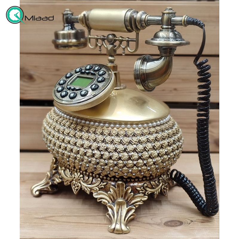 تلفن سلطنتی رومیزی رایکا مدل 310، تلفن سلطنتی با طراحی طرح نقش برجسته روی بدنه تلفن، شماره گیر دکمه ای و دارای کالر آیدی، دکوری شیک و جذاب مناسب منزل و محل کار| رنگ طلایی تلفن کلاسیک
