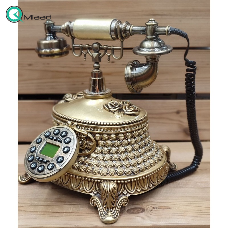 تلفن سلطنتی رومیزی رایکا مدل 320، تلفن سلطنتی با طراحی طرح نقش برجسته روی بدنه تلفن، شماره گیر دکمه ای و دارای کالر آیدی، دکوری شیک و جذاب مناسب منزل و محل کار| رنگ طلایی تلفن کلاسیک