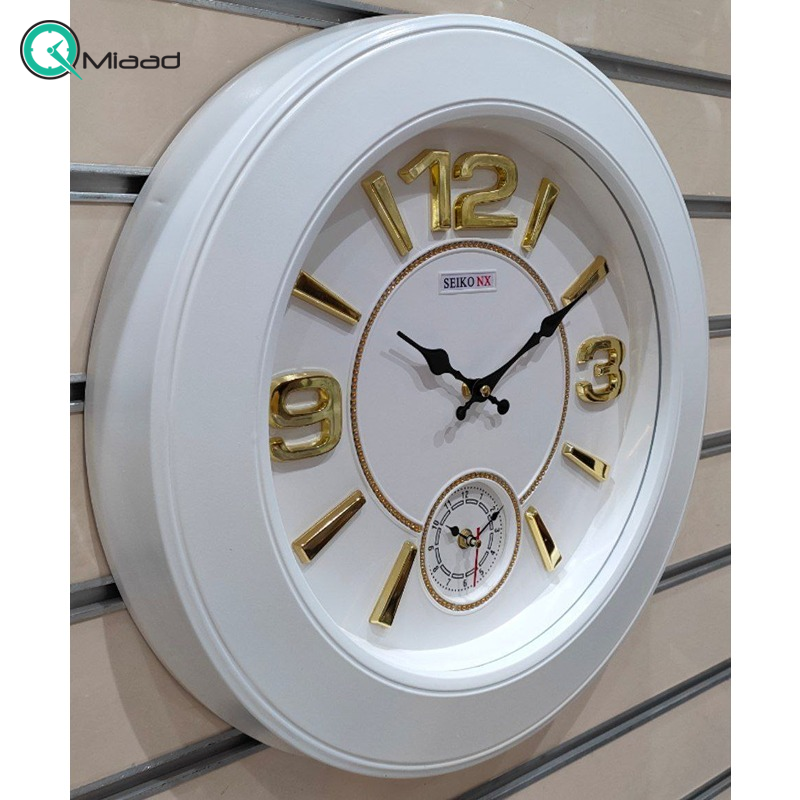 ساعت دیواری سیکو مدل NX، ساعت دیواری دو زمانه با تنوع رنگی، دارای موتور روانگرد و اعداد برجسته آبکاری شده لاتین، سایز 50، رنگ سفید طلایی  ساعت دیواری چهارگوش