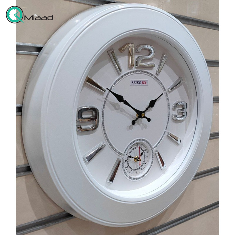 ساعت دیواری سیکو مدل NX، ساعت دیواری دو زمانه با تنوع رنگی، دارای موتور روانگرد و اعداد برجسته آبکاری شده لاتین، سایز 50، رنگ سفید نقره ای  ساعت دیواری چهارگوش