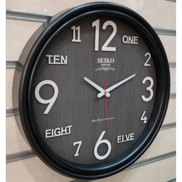 ساعت دیواری سیکو گرد مدل S 600، ساعت دیواری اقتصادی با تنوع رنگ بندی، دارای عدد چوبی و شب نما، متریال پلاستیک بدنه، سایز 55، رنگ مشکی