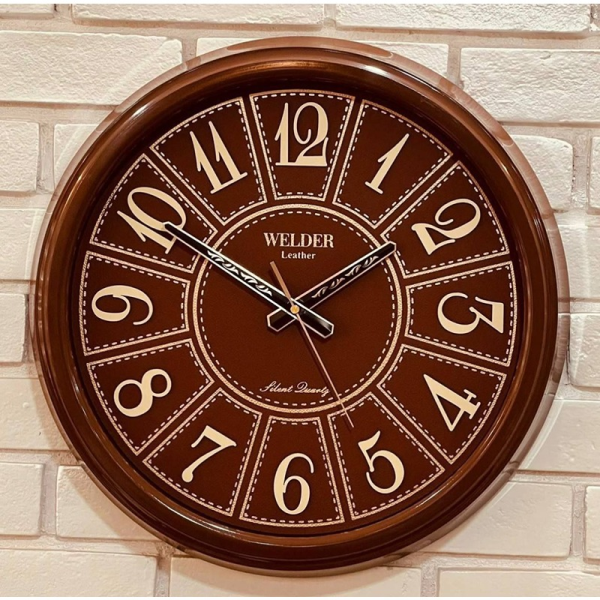 ساعت دیواری ولدر Welder مدل 540، ساعت دیواری سایز 43 با عقرب های متفاوت، دارای رنگ بندی و صفحه چرمی، فونت لاتین اعداد، دارای موتور درجه یک میتسو، رنگ قهوه ای روشن