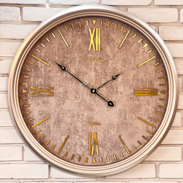 ساعت دیواری ولدر Welder مدل 7015، ساعت دیواری سایز 70 با صفحه کاغذ دیواری ترک، دارای رنگ بندی، شماره برجسته مولتی با فونت رومی، دارای موتور درجه یک میتسو، رنگ طوسی