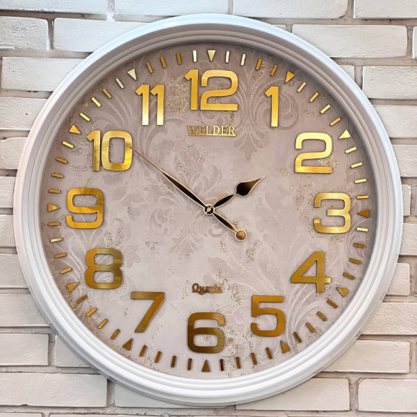 ساعت دیواری ولدر Welder مدل 7016، ساعت دیواری سایز 70 با صفحه کاغذ دیواری ترک، دارای رنگ بندی، شماره برجسته مولتی با فونت لاتین، دارای موتور درجه یک میتسو، رنگ سفید